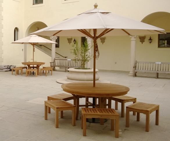 teak dining table with umbrella and backless benches at UCLA